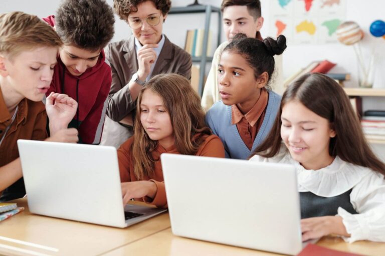 Seesaw students working on laptops