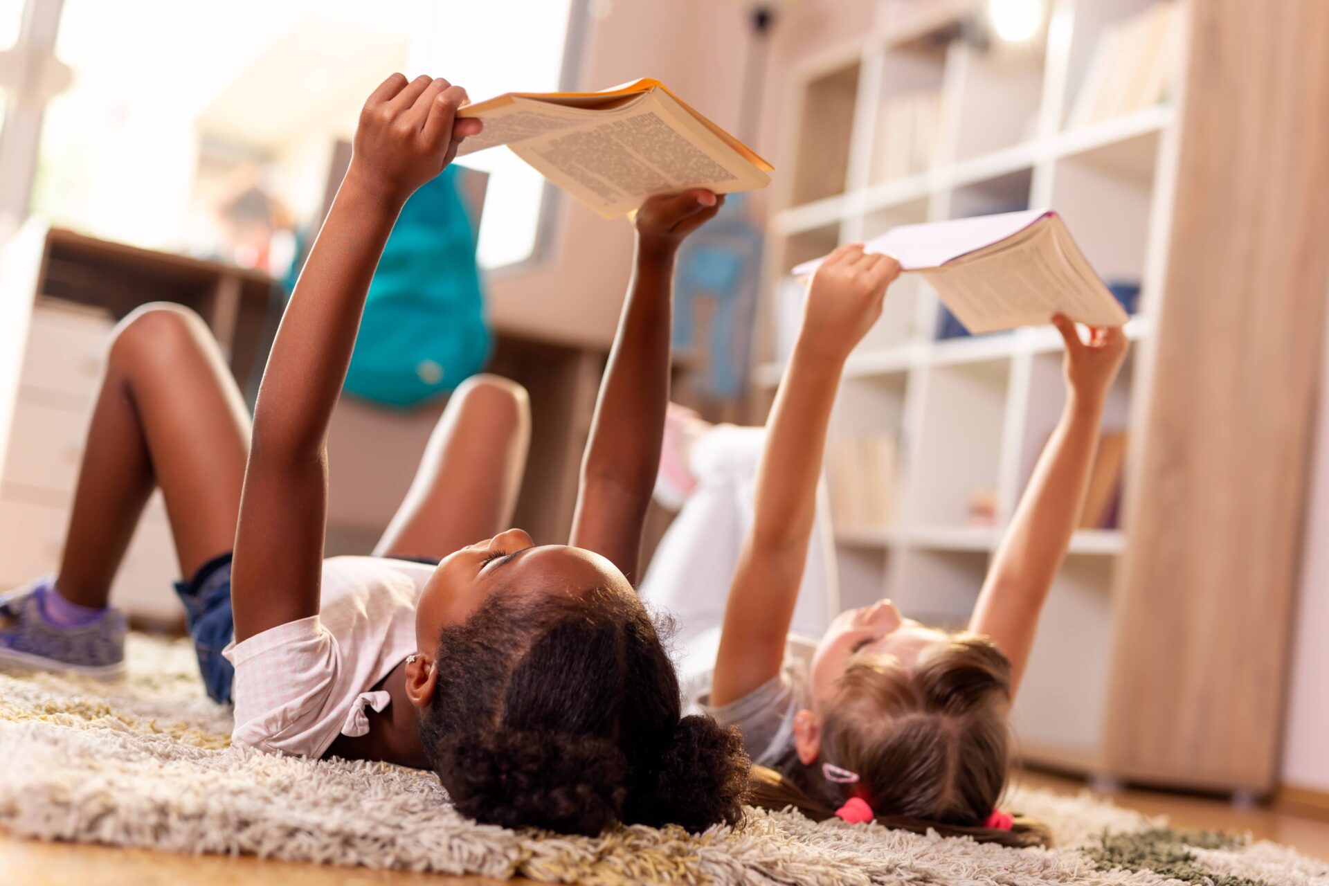 Children reading books on the floor