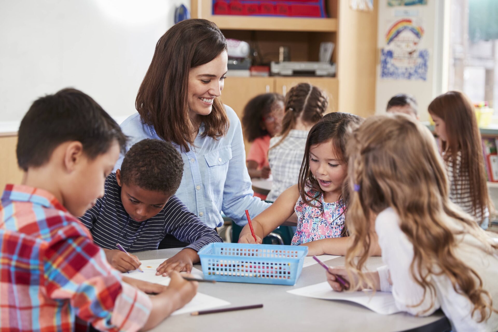 Teacher working with a small group of elementary students