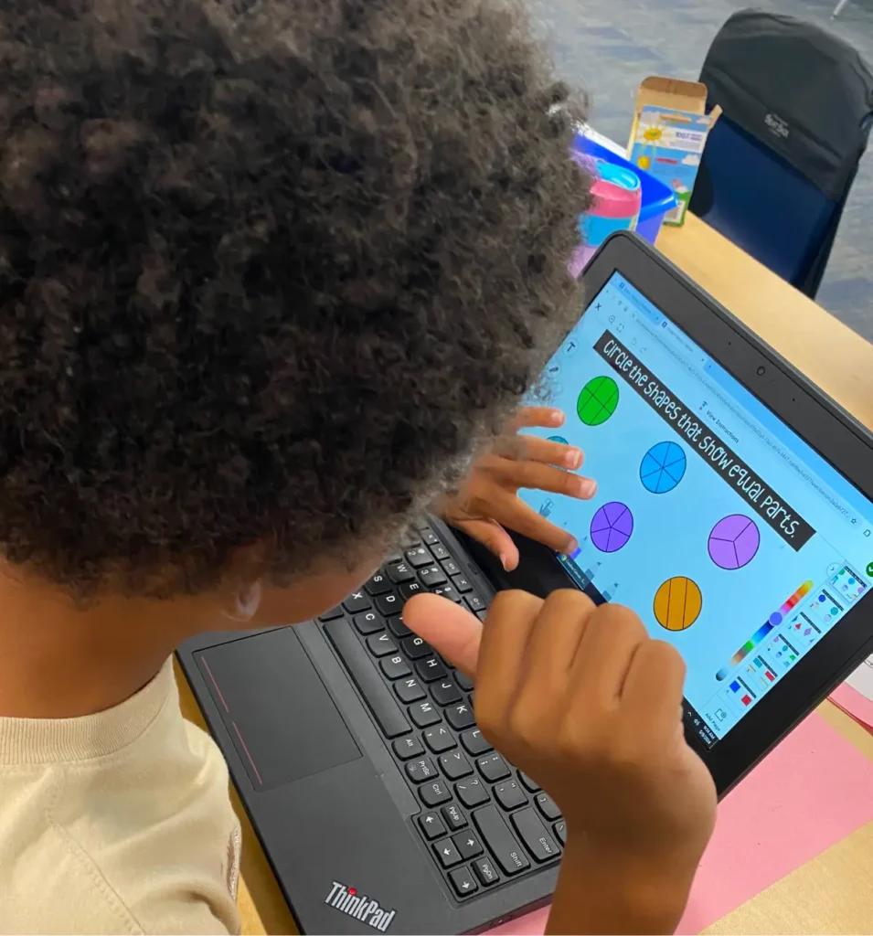 Student using laptop in classroom