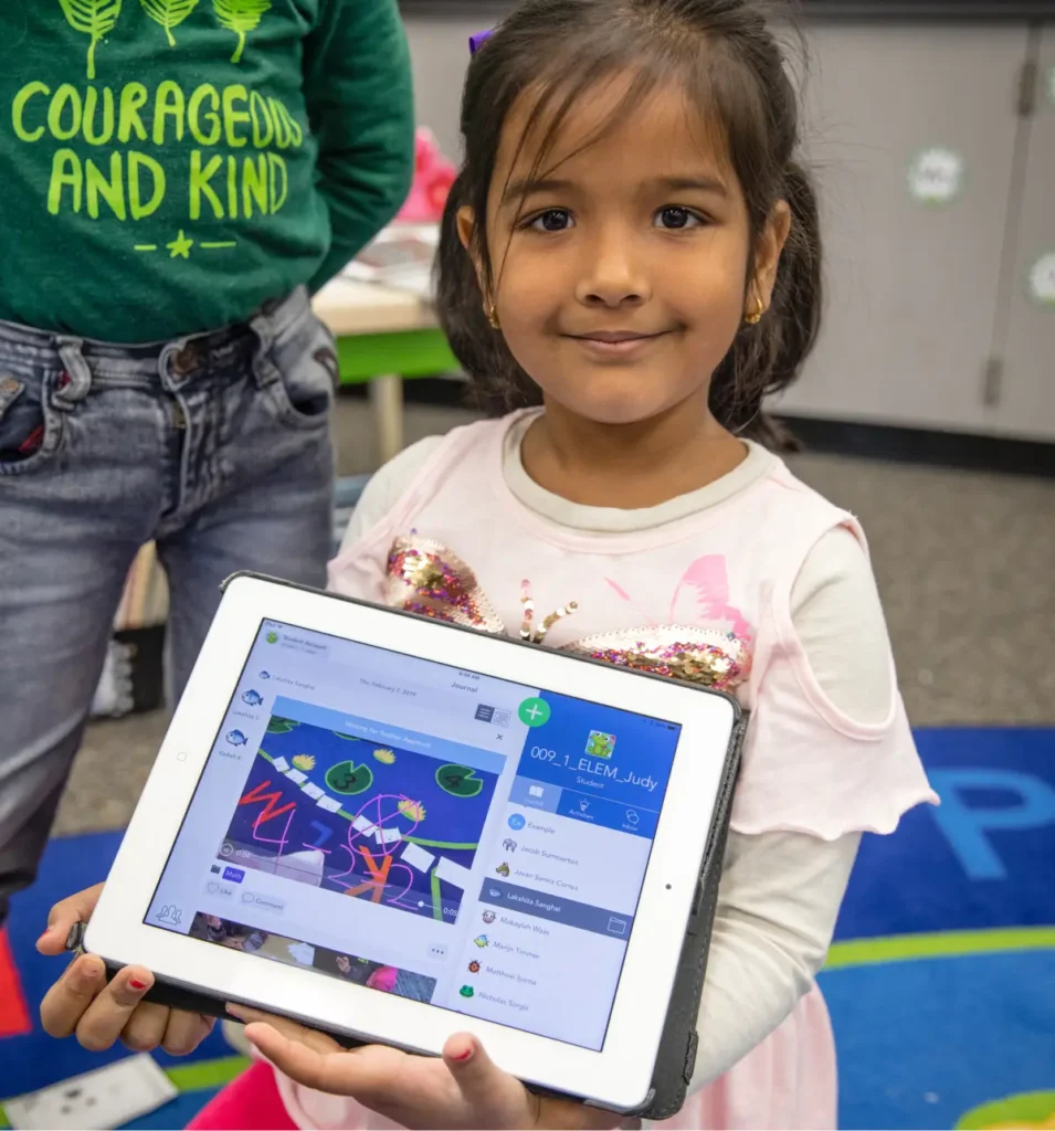 Student showing tablet with Seesaw lesson