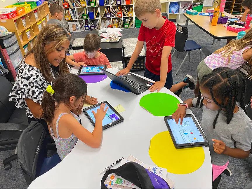 Teacher with students reviewing work