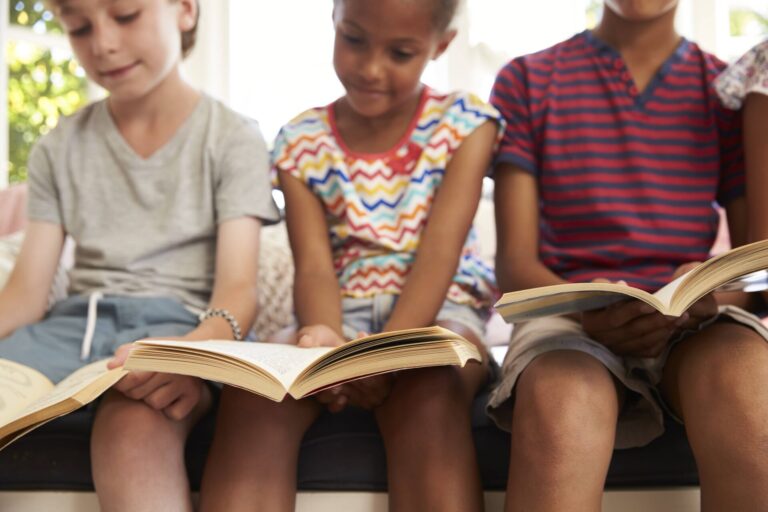 Children reading on a window seat