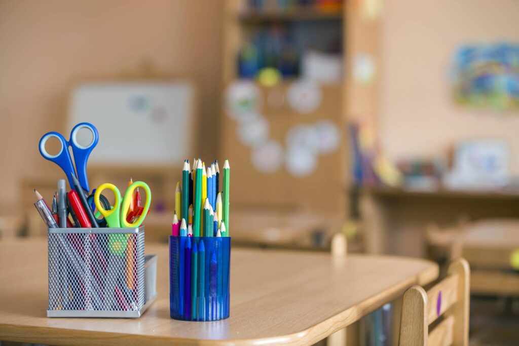 Colored pencils and scissors on a desk