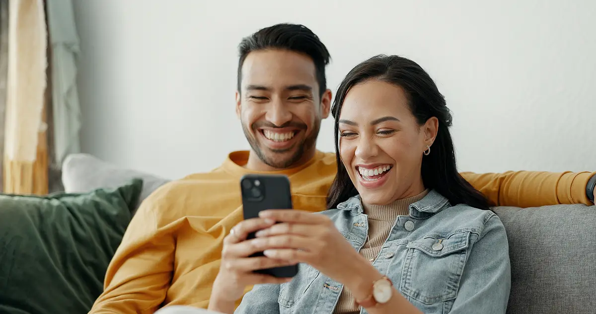 couple looking at phone smiling