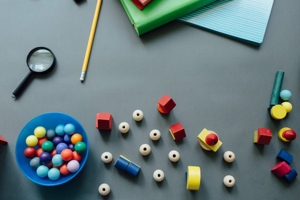Classroom desk with school supplies scattered across it