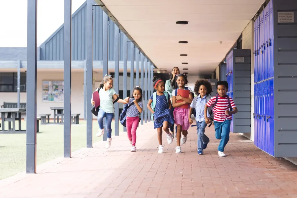 diverse group of elementary students running