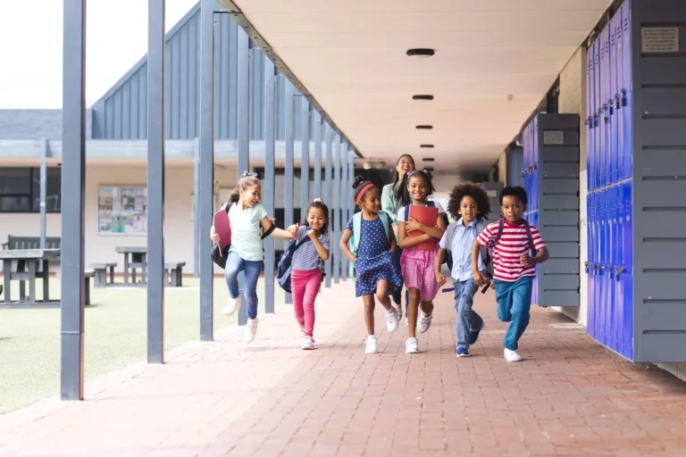 diverse group of elementary students running