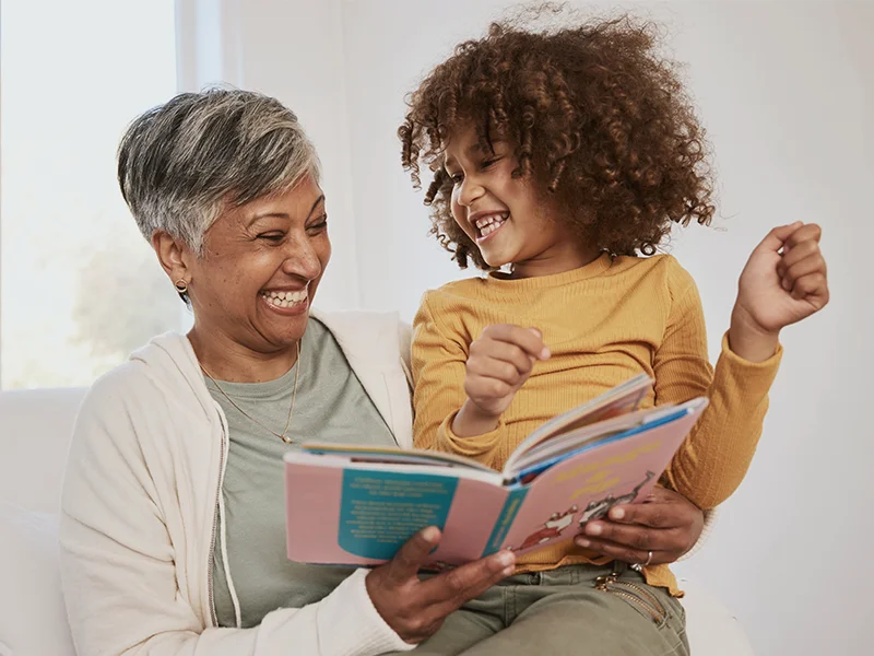 a guardian and child happily read together