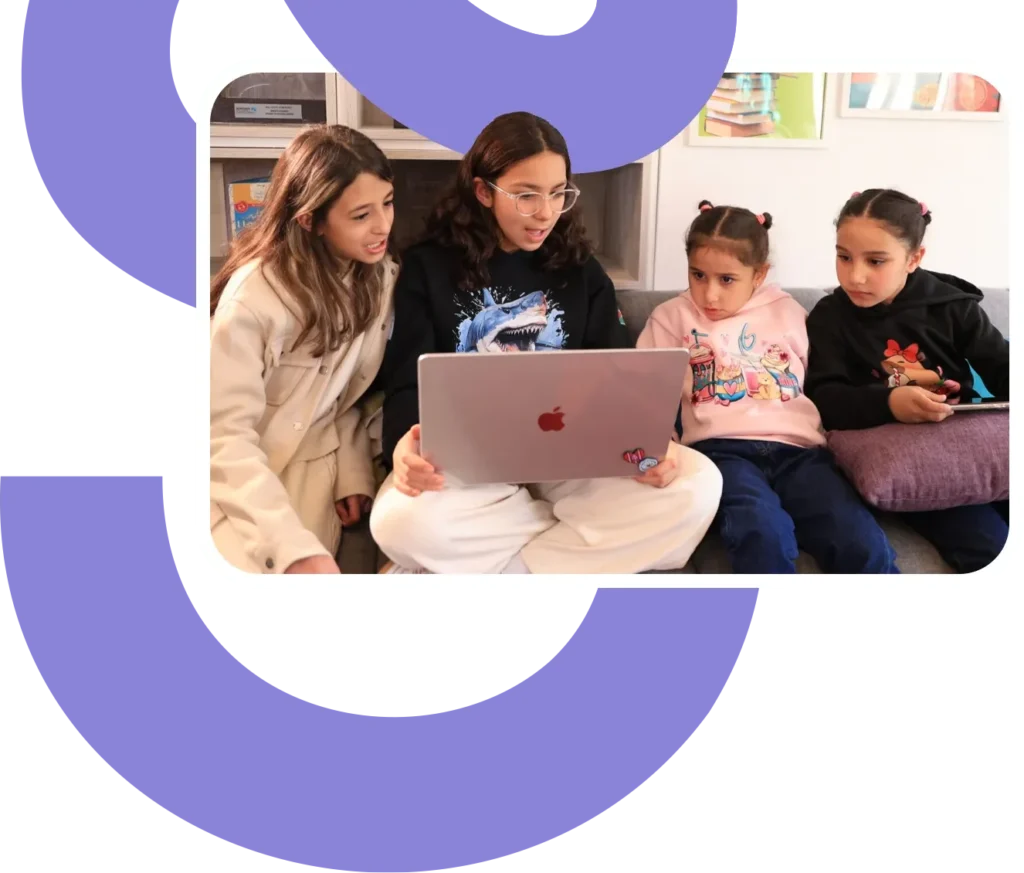 a group of students work on a laptop together