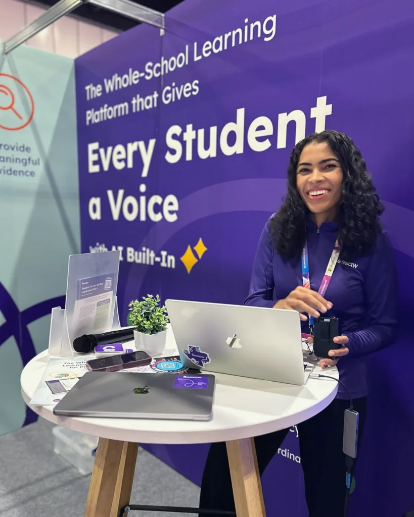 a seesaw employee welcomes visitors to the booth