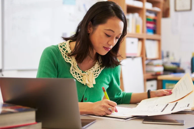a school leader works at her desk
