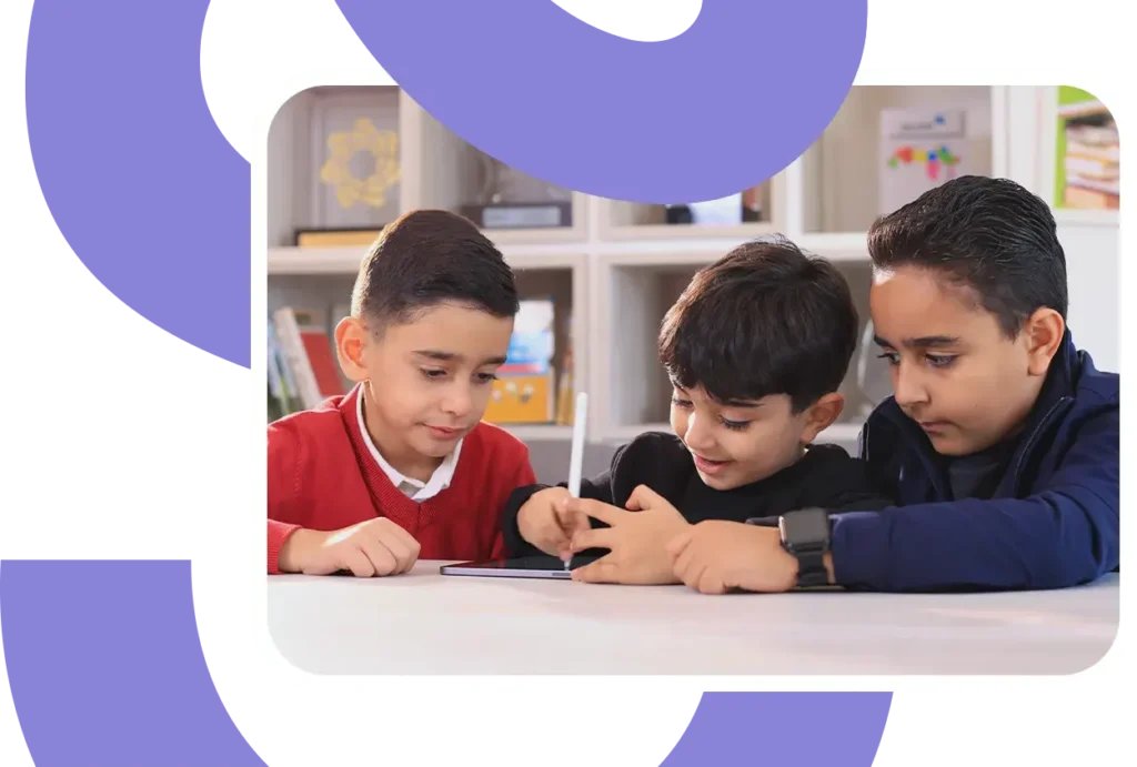 three students work together on a tablet
