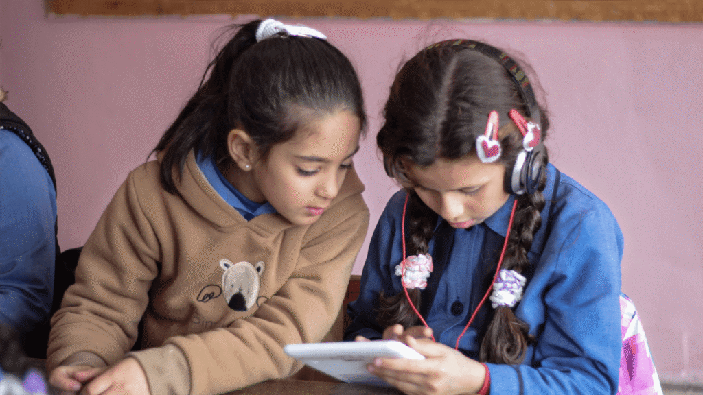 Two arab female students using a tablet